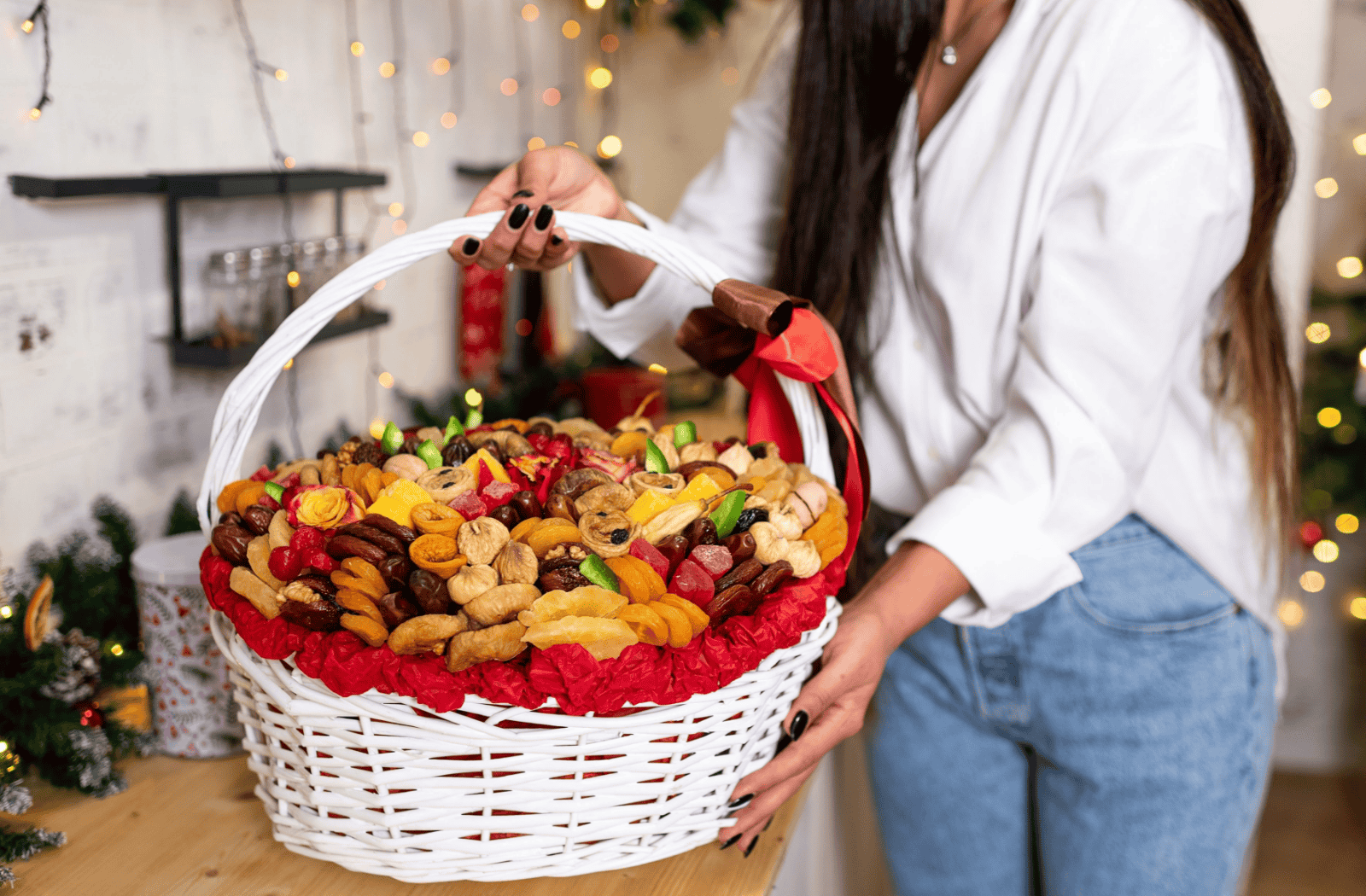 A person holds a white basket jam-packed with snack skewers and fruits!