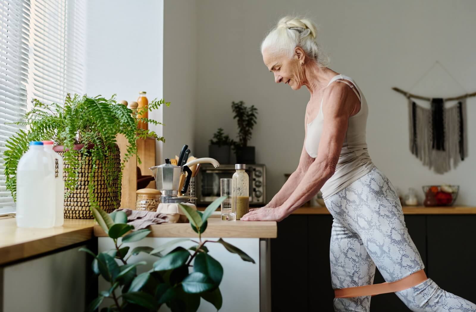 A senior performs gentle exercises from the comfort of their home to boost their immune system.